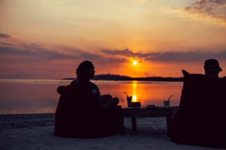 silhouette of person sitting on chair during sunset by Kaur Martin courtesy of Unsplash.