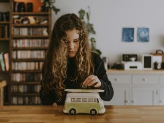 girl wearing black sweatshirt playing toy car by Annie Spratt courtesy of Unsplash.